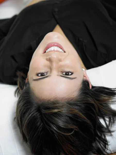 Portrait of a businesswoman lying on the bed and smiling