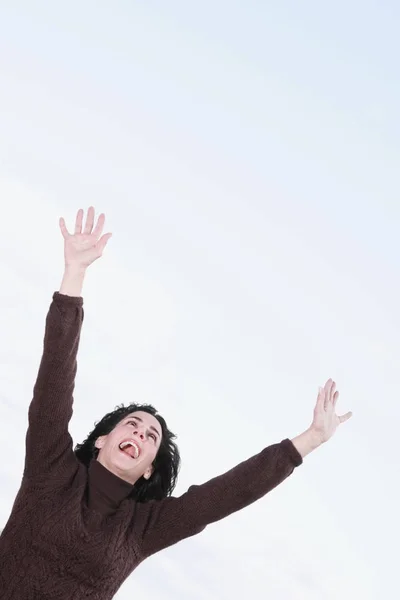 Low angle view of a mature woman shouting with her arms raised