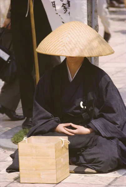 Monk begging at the sidewalk, Tokyo Prefecture, Japan