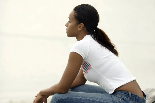 Side profile of a young woman sitting