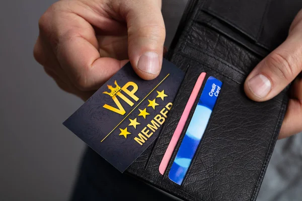 財布からVipメンバーカードを削除する男の手のクローズアップ — ストック写真