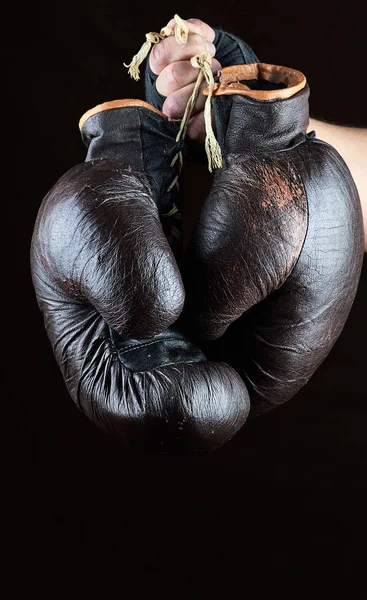 Hand Holds Pair Old Leather Brown Boxing Gloves Black Background — Stock Photo, Image