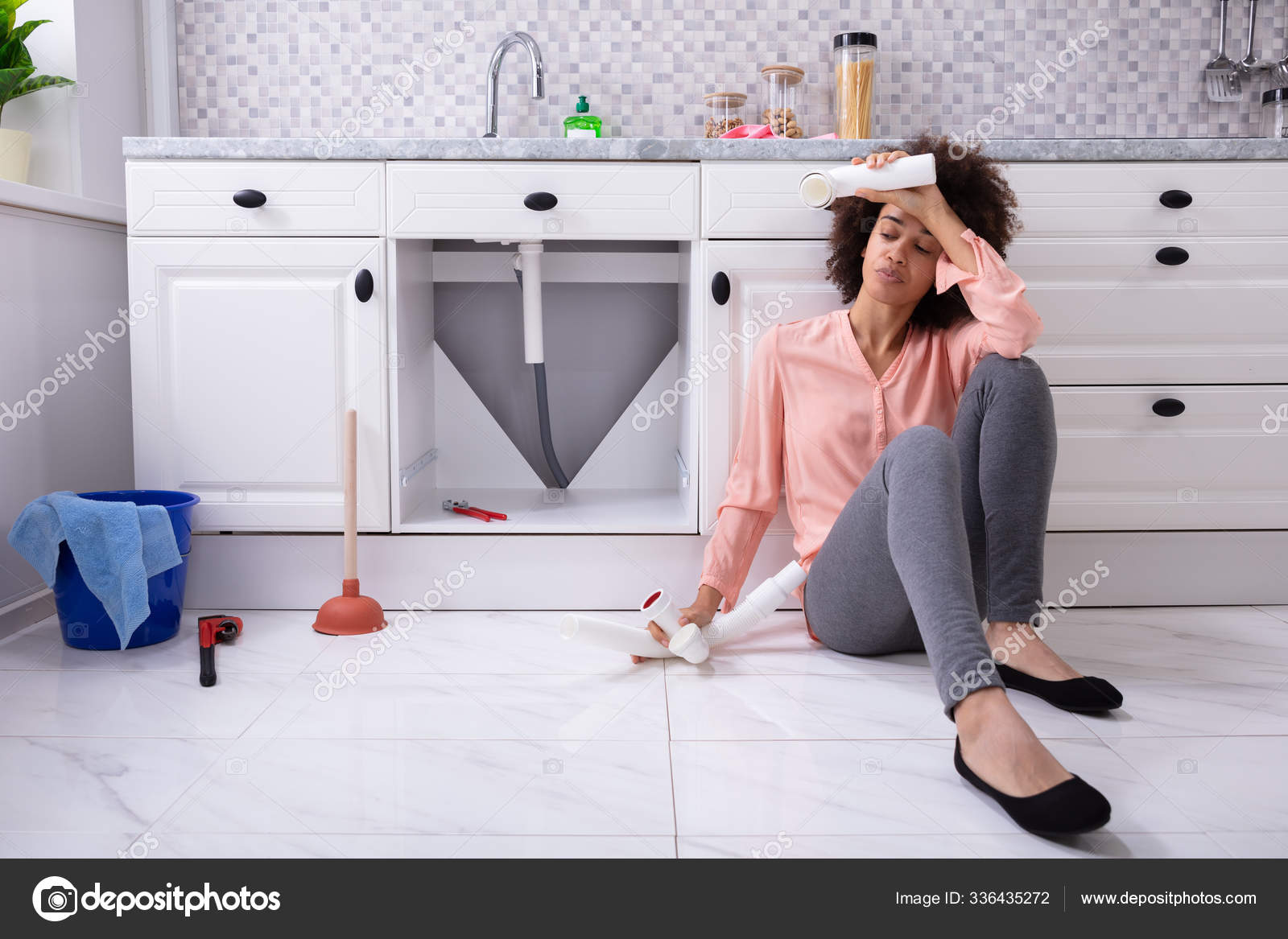 Disappointed African Young Woman Holding Broken Sink Pipe Hand Sitting —  Stock Photo © PantherMediaSeller #336435272