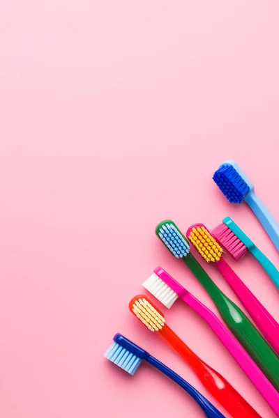 Colorful Toothbrushes Pink Background Top View — Stock Photo, Image