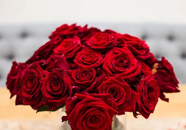 Red bouquet of red roses. Wedding flowers on gray background. Selective focus, valentines day concept beauty