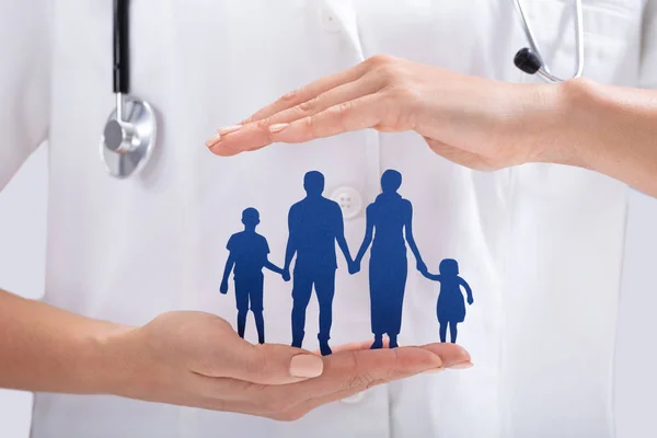 Close Doctor Hand Protecting Blue Family Paper Cut Out — Stock Photo, Image