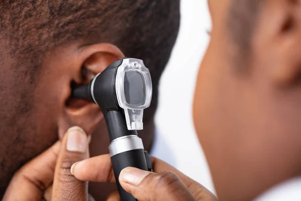 Médico Africano Examinando Oído Del Paciente Masculino Con Otoroscopio — Foto de Stock