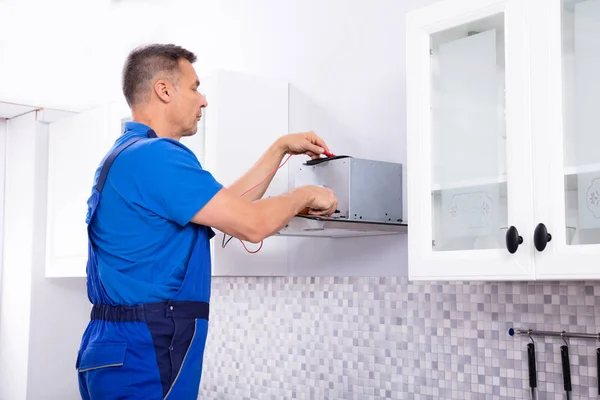 Elevated View Male Technician Checking Extractor Filter Digital Multimeter Kitchen — Stock Photo, Image