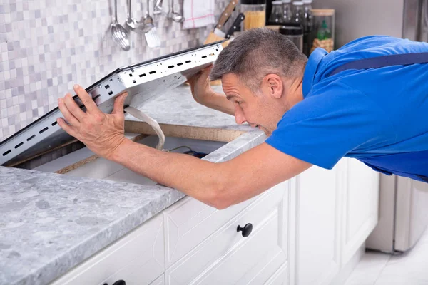 Mature Repairman Installing Induction Stove Kitchen — Stock Photo, Image