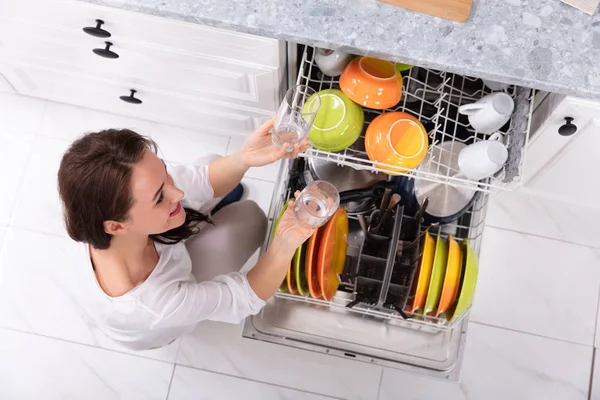 Smiling Young Woman Arranging Plates Dishwasher Home — Stock Photo, Image