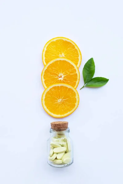 Vitamin Flasche Und Pillen Mit Orangefarbenen Früchten Auf Weißem Hintergrund — Stockfoto