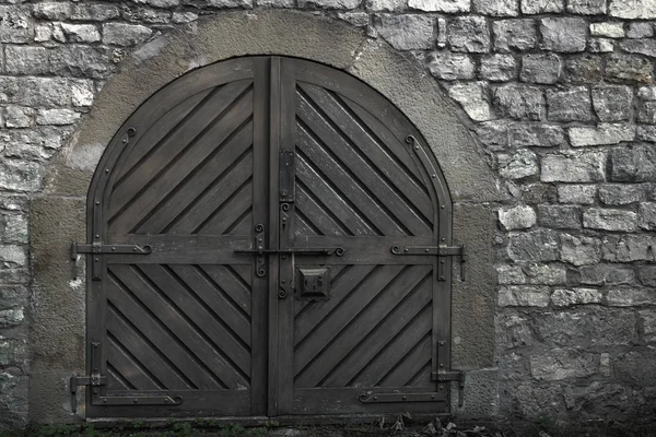 閉じられた木造門 金属製の強い中世の構造物 古代の建物からの石壁 — ストック写真