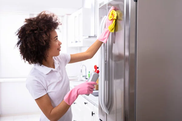 Close Serious Young Woman Cleaning Refrigerator Yellow Napkin Spray Detergent — Stock Photo, Image