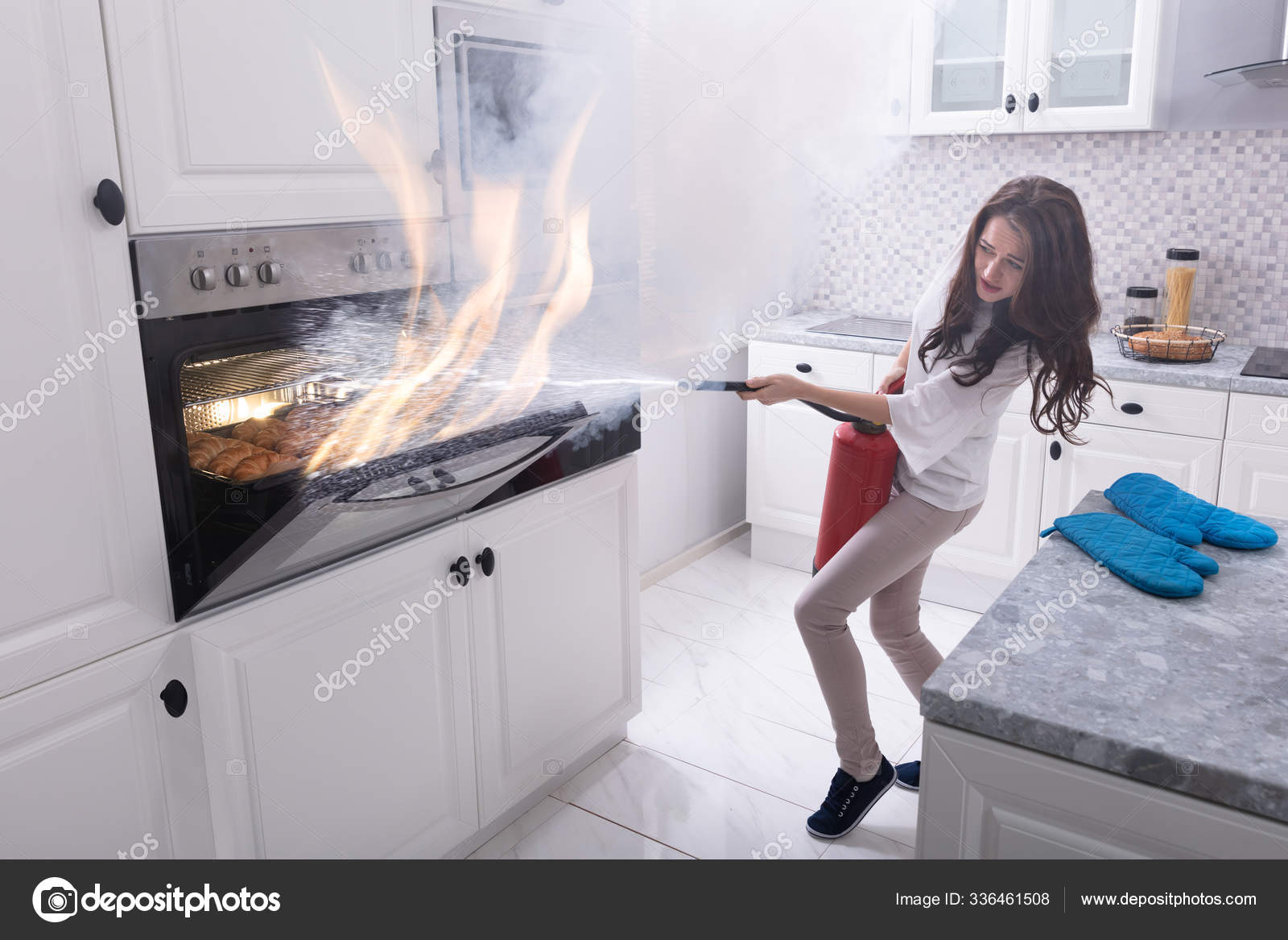 Woman Using Fire Extinguisher Stop Fire Coming Out Oven Kitchen Stock Photo Image By Panthermediaseller 336461508
