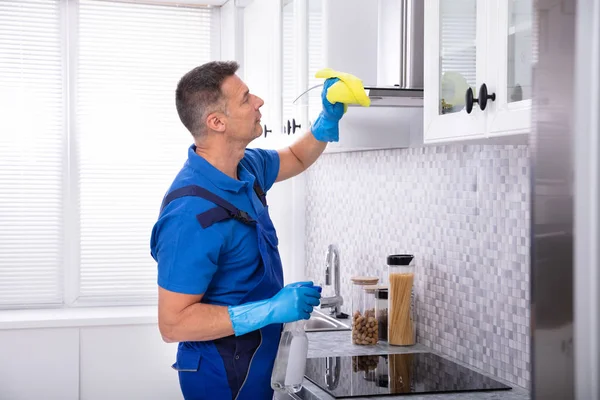 Mature Male Janitor Cleaning Cooker Hood Napkin Spray Detergent Kitchen — Stock Photo, Image