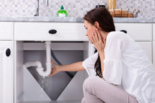 Rückansicht Einer Frau Die Versucht Wasseraustritt Aus Spülrohr Küche Stoppen — Stockfoto