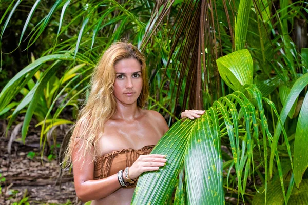 Wild woman hidden in the green jungle