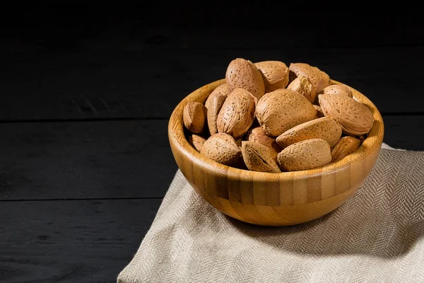 Whole Organic Almond Nuts Shell Wooden Bowls Black Table Selective — Stock Photo, Image