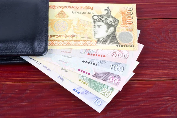 Bhutanisches Geld Schwarzen Portemonnaie Auf Holzgrund — Stockfoto