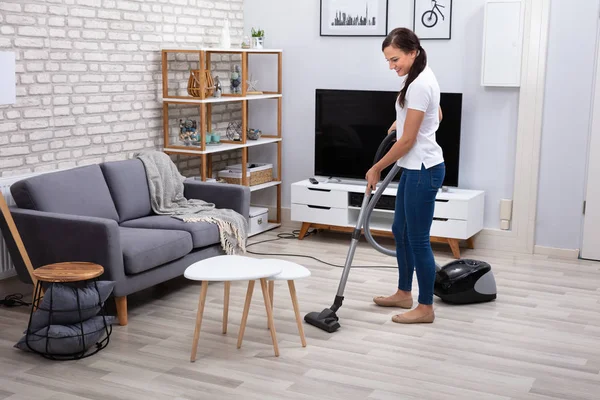 Happy Young Female Janitor Cleaning Floor Vacuum Cleaner — стоковое фото