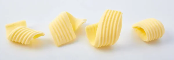 Set Different Butter Curls Rolls Row Close White Surface Background — Foto de Stock