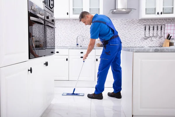 Side View Male Janitor Cleaning White Floor Mop Kitchen — стоковое фото