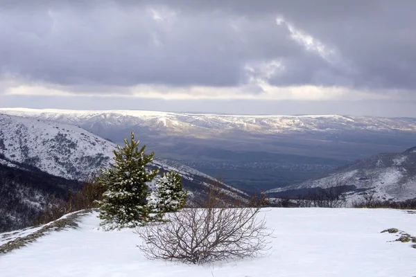 山の中で冬の風景 曇りの日の朝 雲の中から太陽の光線のピークと雪の上に落ちる帽をかぶったピークは 下の谷と街を見ることができます ヤルタクリミア半島 — ストック写真