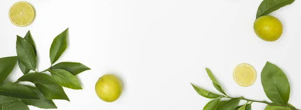 Some Fresh Green Limes Green Twigs Lie White Background — Stock Photo, Image