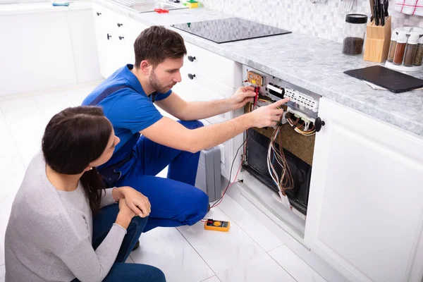 Woman Looking Male Technician Checking Dishwasher Digital Multimeter Kitchen — Stock Photo, Image