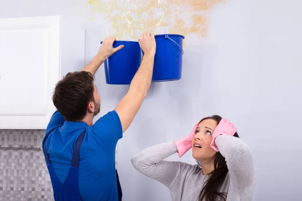 Frustrate Woman Handyman Collecting Water Damaged Ceiling Blue Bucket — Stock Photo, Image