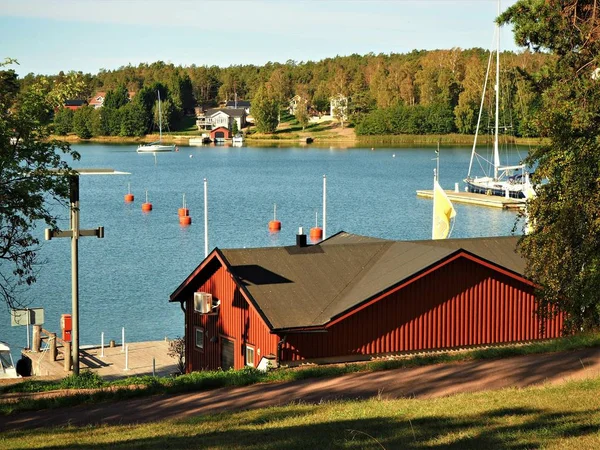 View over a Baltic Sea channel with sailing boats from Mariehamn in Aland, Finland, to a wooded shore with houses