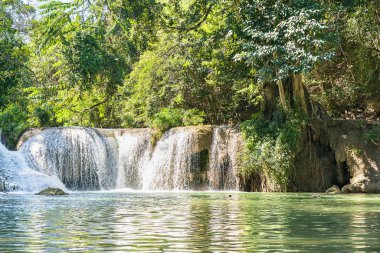 Waterfall in a forest on the mountain in tropical forest at Waterfall Chet Sao Noi in National park Saraburi province, Thailand clipart