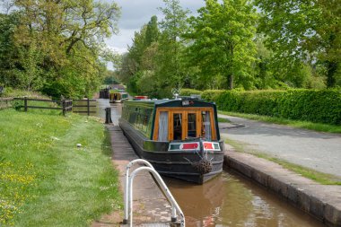 Lock with an approaching narrowboat on the LLangollen Canal in Shropshire, UK clipart
