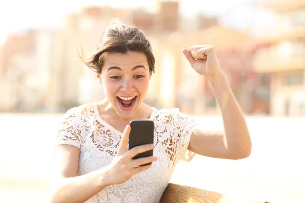 Mujer Emocionada Leyendo Noticias Increíbles Teléfono Inteligente Sentado Banco Calle — Foto de Stock