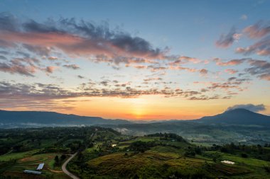 Beautiful nature landscape of the colorful sky and mountains during the sunrise at Khao Takhian Ngo View Point, Khao Kho attractions in Phetchabun, Thailand clipart
