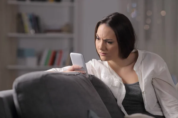 Suspicious Woman Checking Phone Content Sitting Couch Night Home — Stock Photo, Image