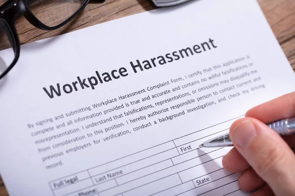 Close Man Hand Filling Workplace Harassment Form — Stock Photo, Image