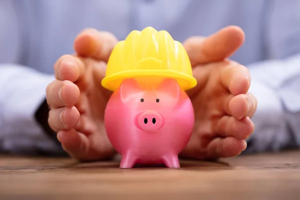 Close Person Hand Protecting Pink Piggy Bank Yellow Hard Hat — Stock Photo, Image