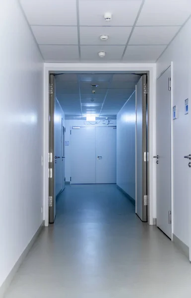Blue Illuminated Corridor Including Some Doors — Stock Photo, Image