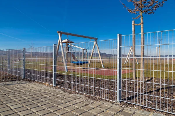 Fenced playground next to a kindergarten