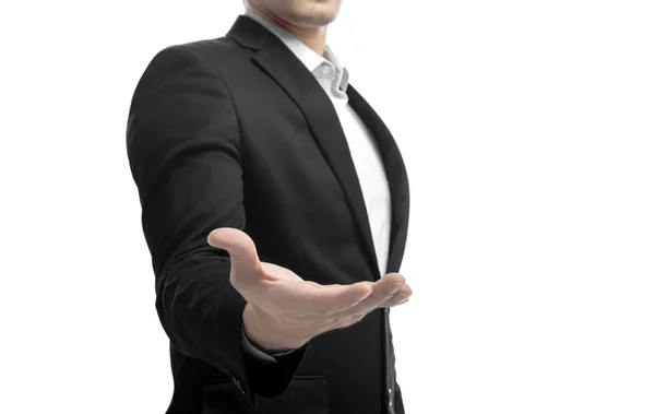 提供握手のオープン手のひらで立って 保持するか何か白い背景に分離を示すスーツのビジネスマン — ストック写真