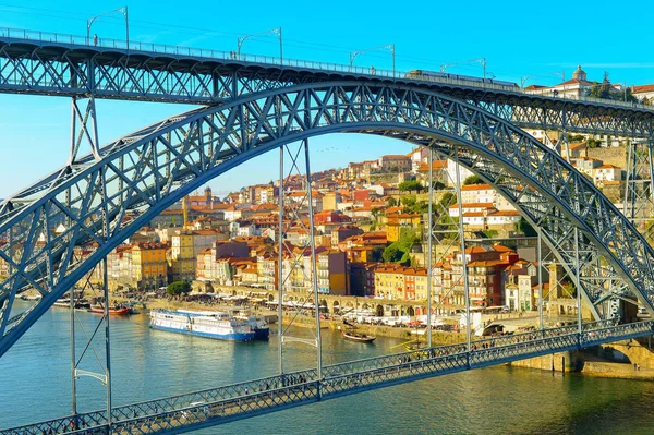 stock image Sunshine cityscape of Porto touristic oldtown by Douro river with Dom Luis I Bridge in foreground, Portugal
