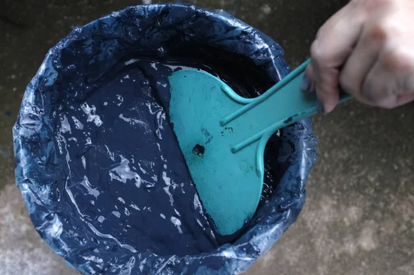 Making indigo dye, Indigo plant fermentation in clay pot . Testing color blue indigo