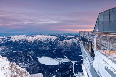 View of frozen lake Eibsee from Zugspitze mountain summit at daybreak clipart
