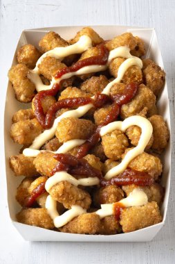 close up of rustic fried golden potato tater tots clipart