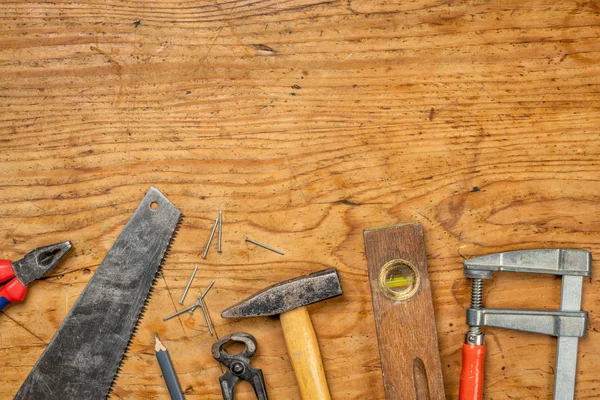 Woodworking tools on a wooden background with copy space