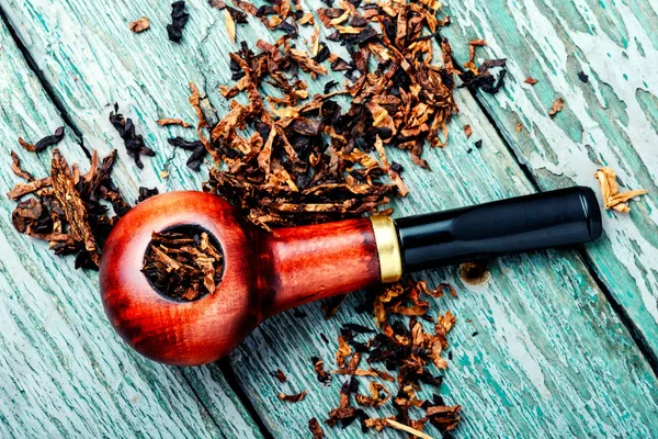 Tobacco pipe or smoking pipe.Classic wooden pipe with tobacco