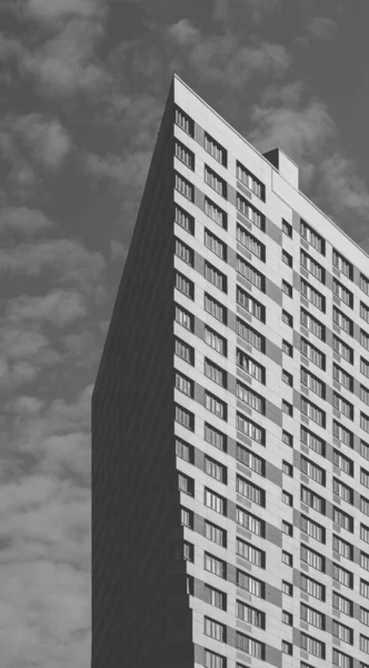 Black and White Skyscraper on the Cloudy Sky Background.