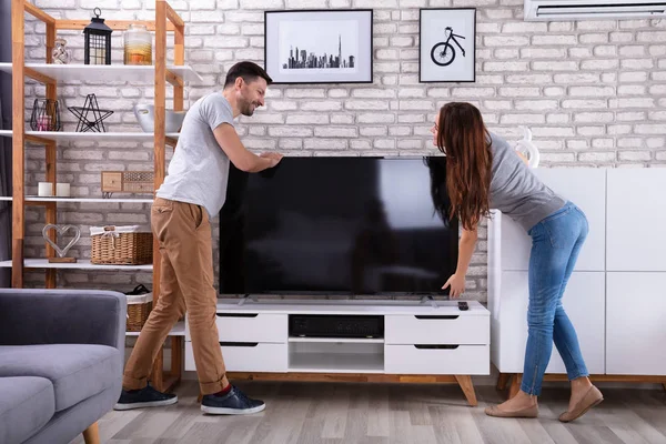 Side View Young Couple Lifting Television Home — Stock Photo, Image