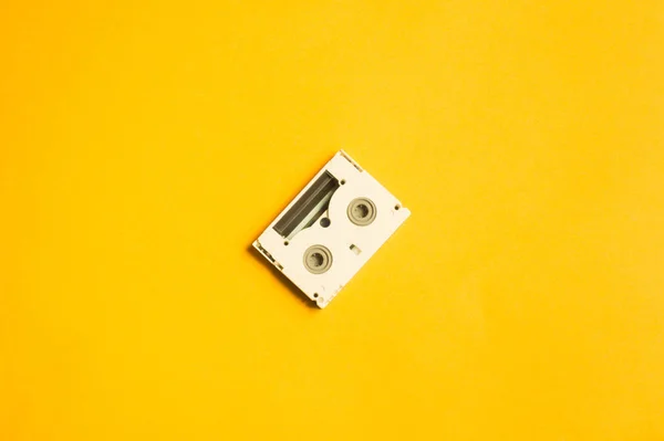 黄色の背景にデジタルビデオカセット 小型カセット コピースペース — ストック写真